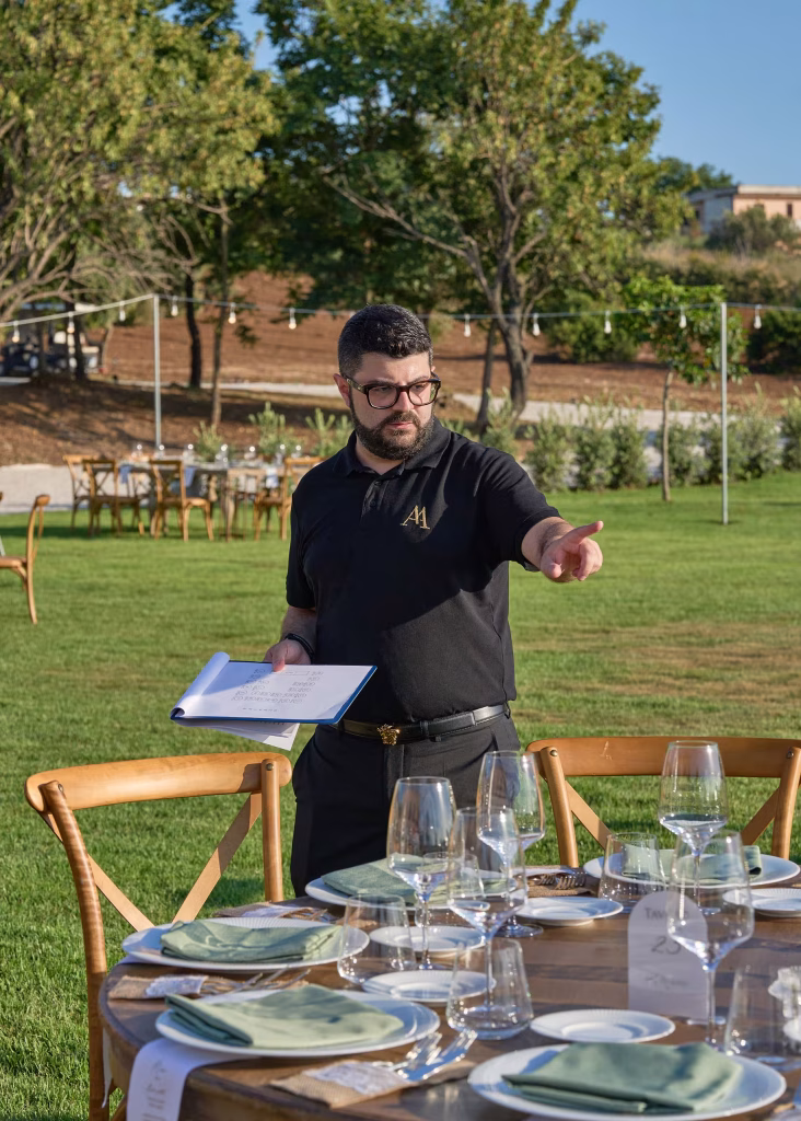 Loris coordinating an outdoor wedding table setup